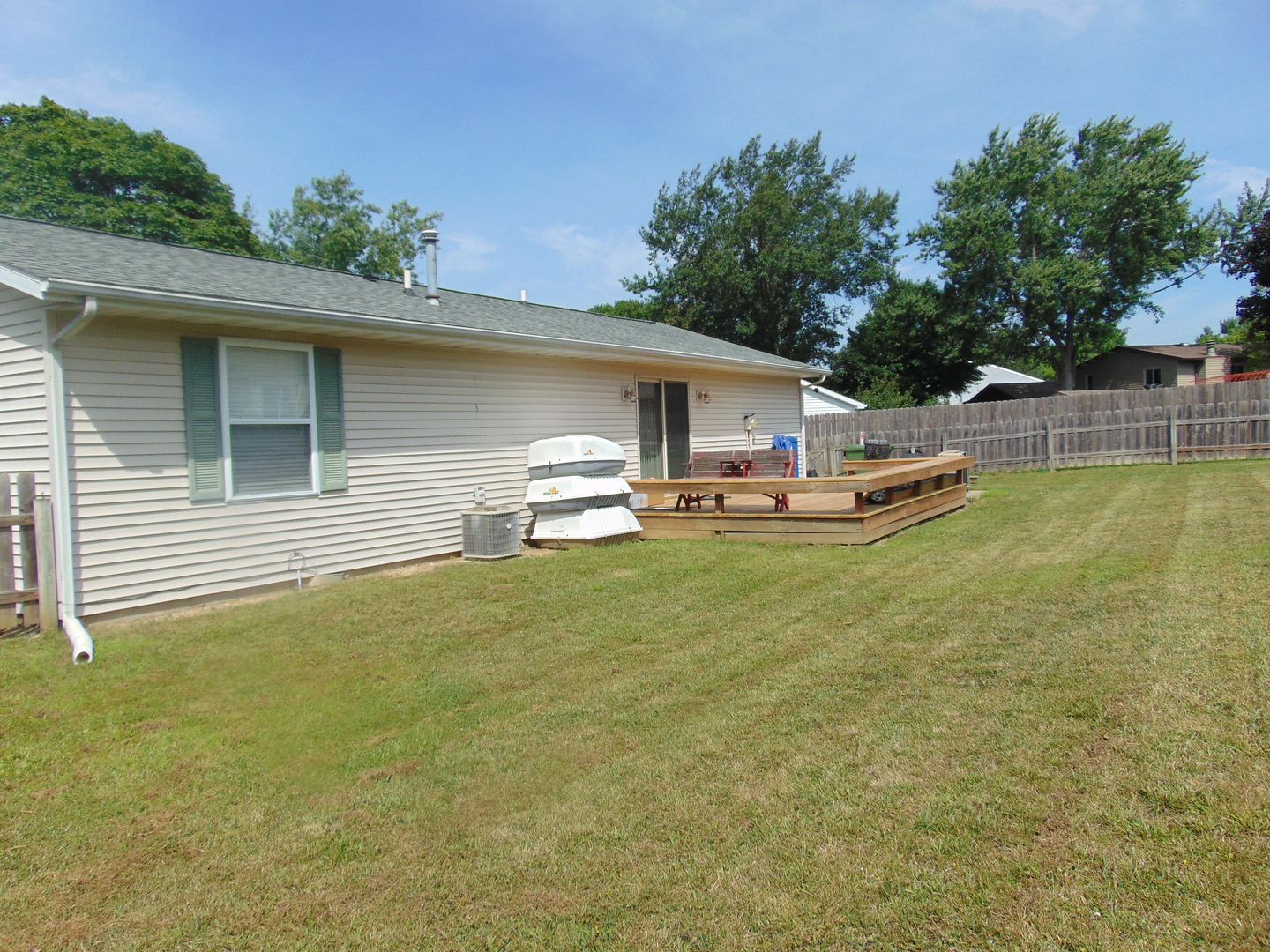 502 Richard Court Mahomet, IL 61853 - Photo 30 of 31 a view of a patio with table and chairs a barbeque and potted plants by side of it