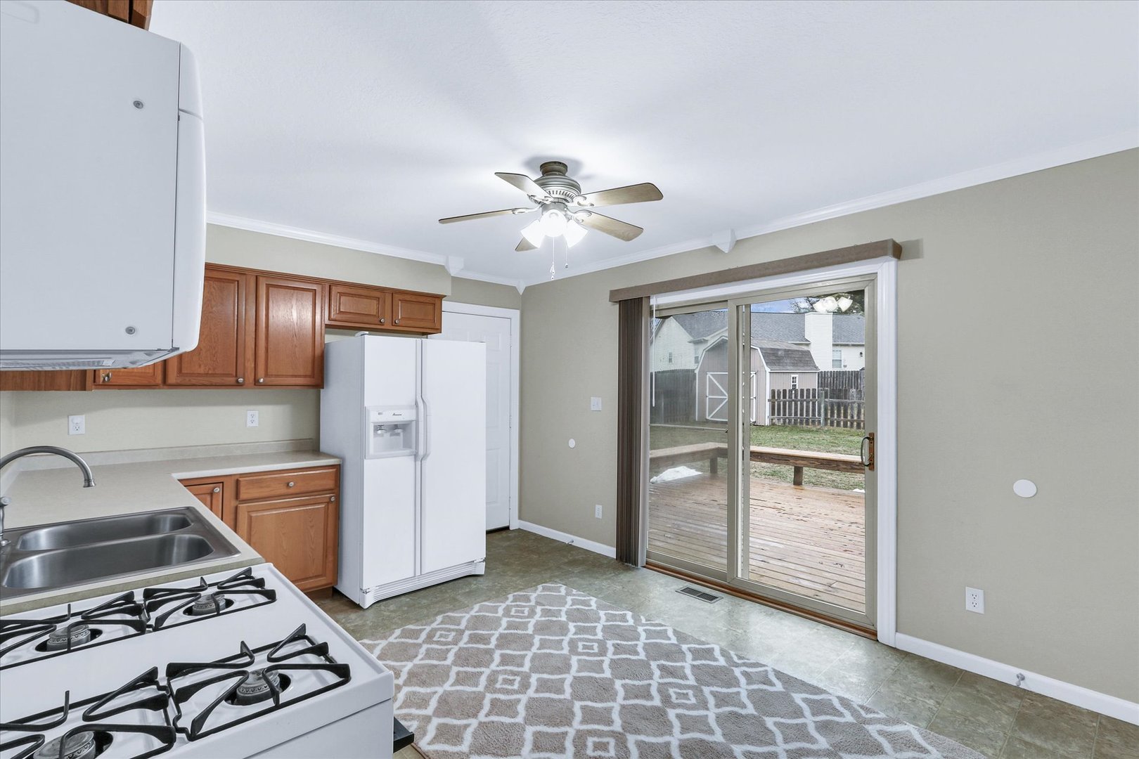 502 Richard Court Mahomet, IL 61853 - Photo 9 of 31 a kitchen with a stove a refrigerator and a stove top oven