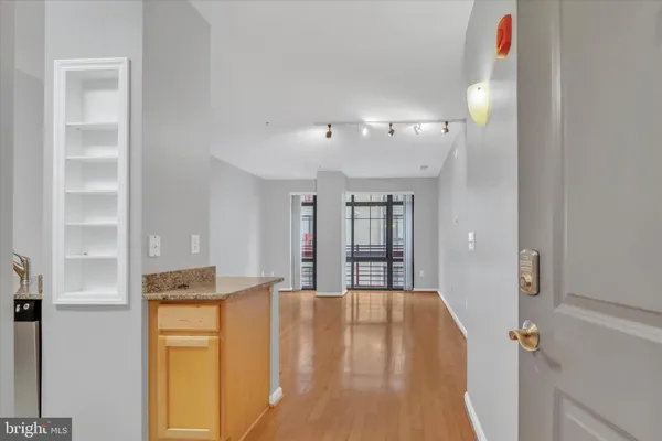 a view of kitchen with kitchen island white cabinets and refrigerator