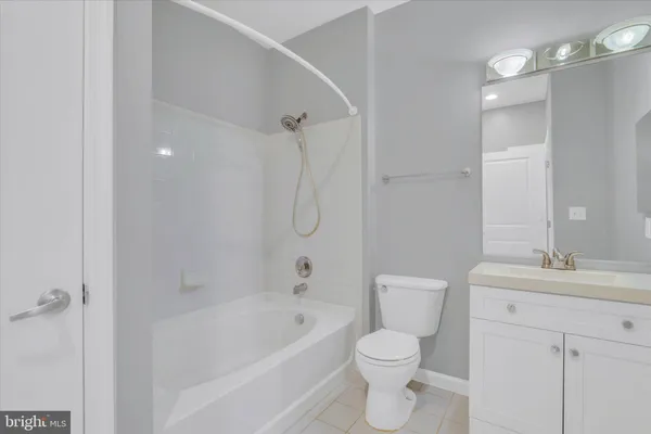 a bathroom with a sink mirror vanity and toilet