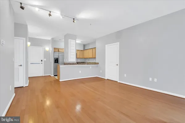 a kitchen with stainless steel appliances granite countertop white cabinets and a refrigerator