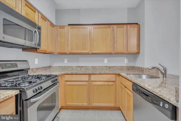 a kitchen with granite countertop a sink and cabinets