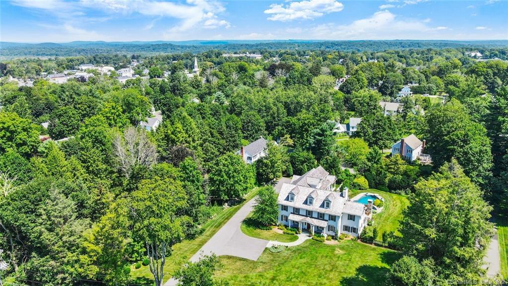 an aerial view of a house with a yard and lake view