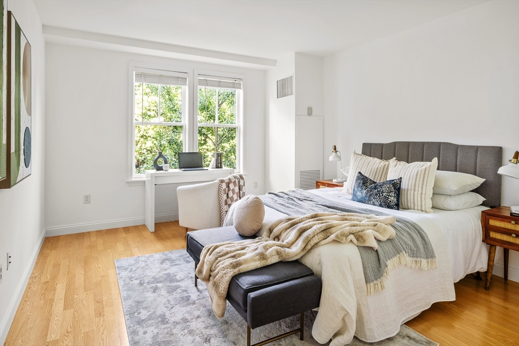 2-14 St Paul Street, Unit 311 Brookline, MA 02446 - Photo 11 of 29 a bedroom with a bed and wooden floor