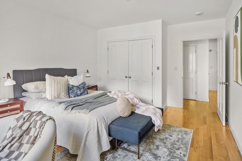 2-14 St Paul Street, Unit 311 Brookline, MA 02446 - Photo 12 of 29 a spacious bedroom with a bed and wooden floor