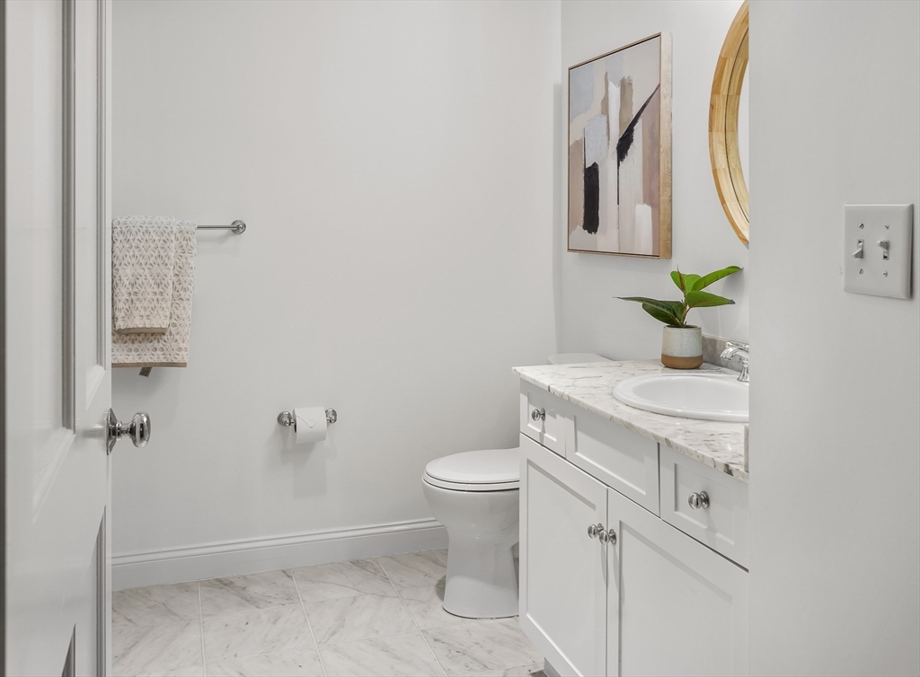 2-14 St Paul Street, Unit 311 Brookline, MA 02446 - Photo 13 of 29 a bathroom with a sink a toilet and mirror