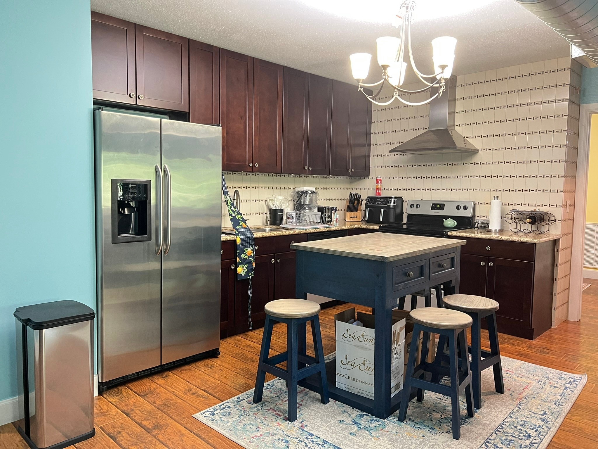 2230 South Piney Point Road, Unit 219 Houston, TX 77063 - Photo 3 of 15 a kitchen with stainless steel appliances granite countertop a sink a microwave refrigerator and chairs