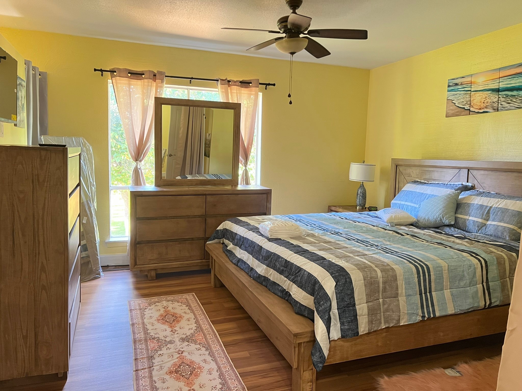 2230 South Piney Point Road, Unit 219 Houston, TX 77063 - Photo 7 of 15 a bedroom with a bed next to a window with a flat screen tv