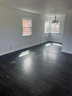 4203 East 12th Place Gary, IN 46403 - Photo 2 of 15 an empty room with wooden floor and windows