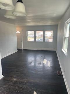 4203 East 12th Place Gary, IN 46403 - Photo 5 of 15 an empty room with wooden floor and windows