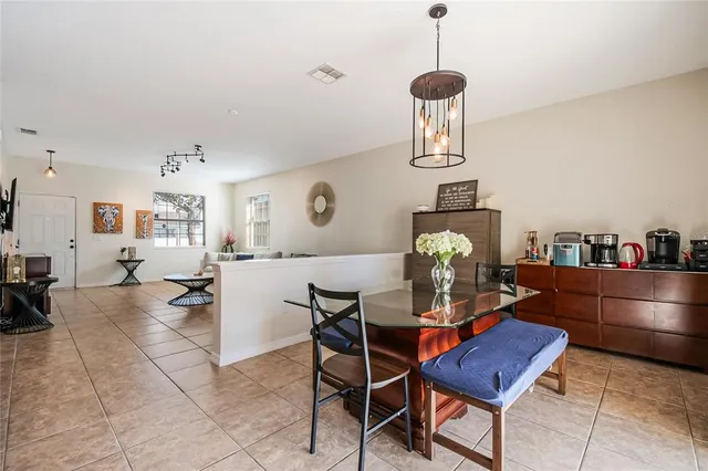 a dining room with furniture and chandelier