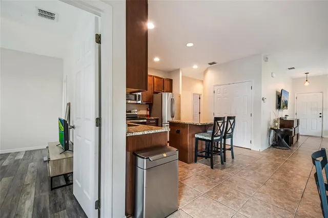 a view of kitchen with kitchen island dining table and chairs