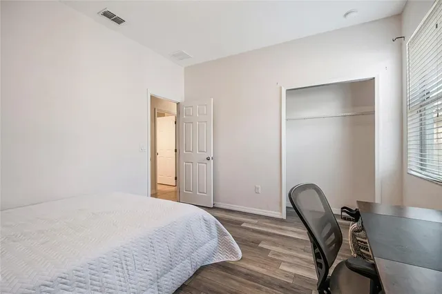 a bedroom with a bed and chair