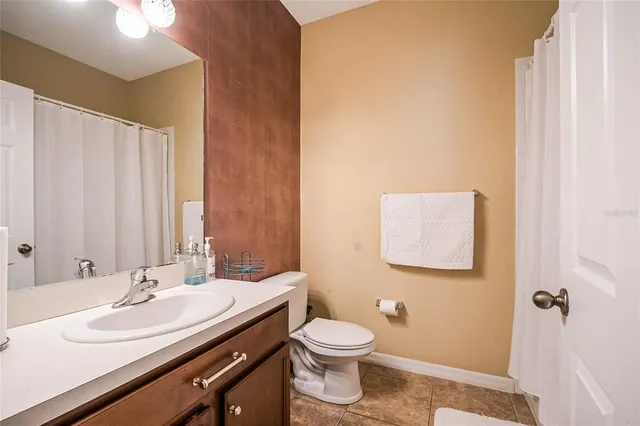 a bathroom with a sink a toilet and mirror