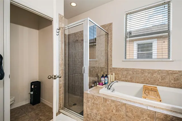 a bath tub sitting in a bathroom next to a window