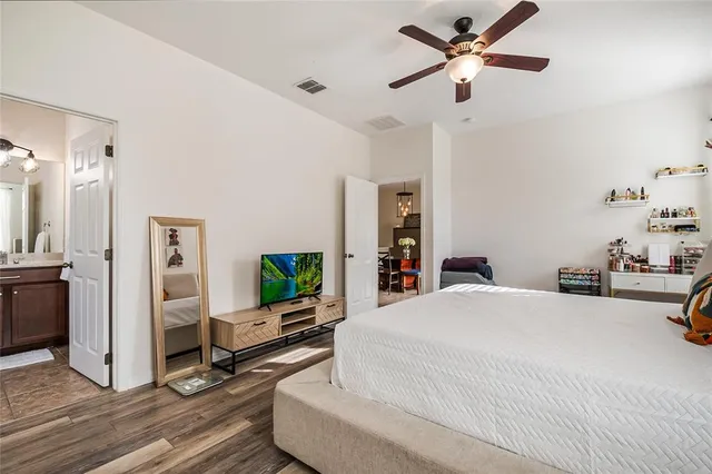 a bedroom with a bed and a flat screen tv