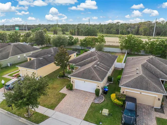 an aerial view of a house with garden space and street view