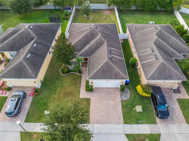 an aerial view of house with a yard