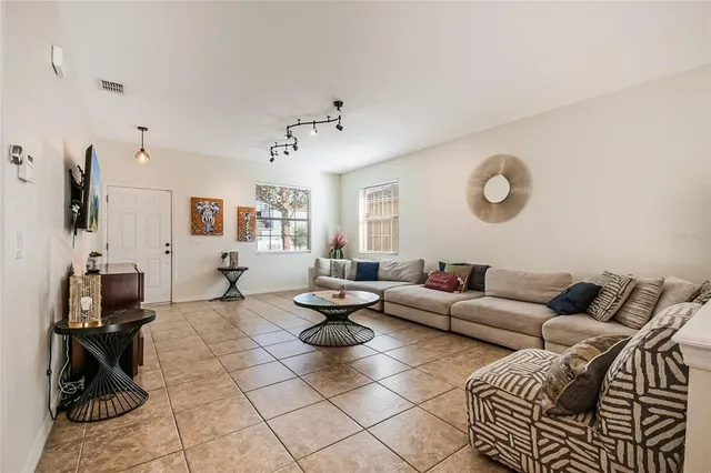 a living room with furniture a rug and a flat screen tv