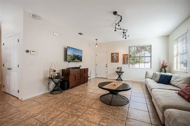a living room with furniture and a flat screen tv