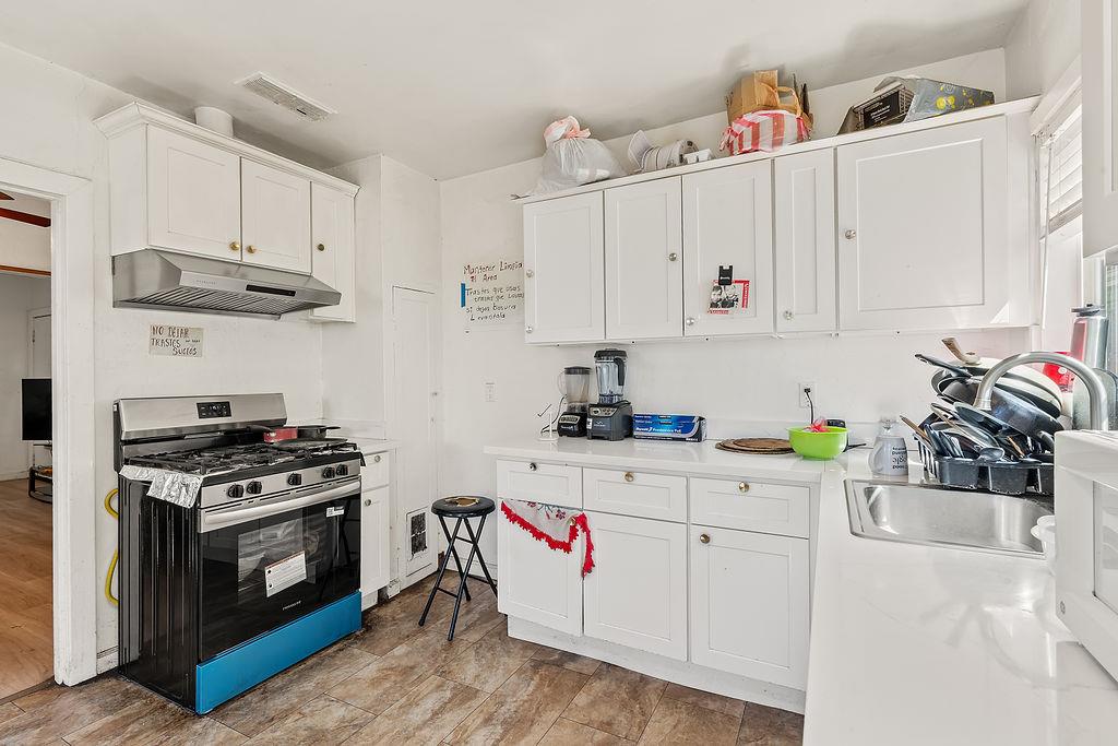 1205 Grand Avenue Santa Rosa, CA 95404 - Photo 23 of 27 a kitchen with white cabinets and white appliances