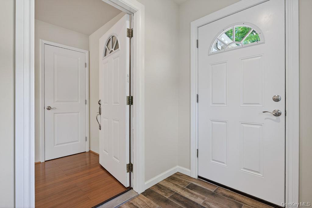 6 Winterberry Road Fishkill, NY 12524 - Photo 5 of 43 Entryway featuring a paneled door with an arched transom window, chrome hardware, and wood-look tile flooring
