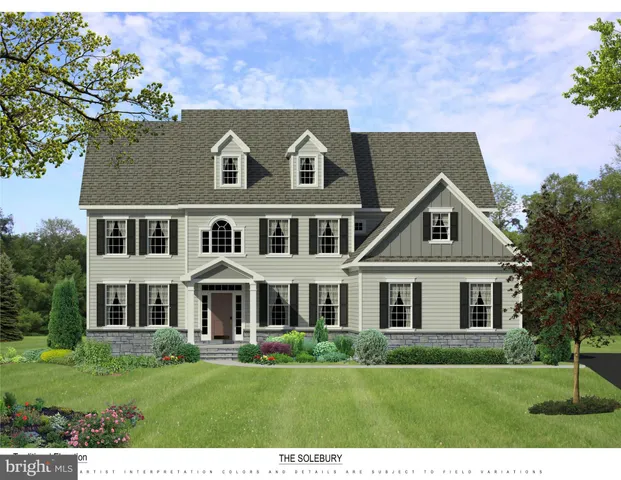 a aerial view of a house next to a yard