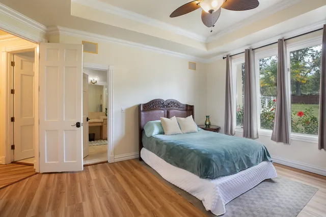 a bedroom with a large bed and a chandelier