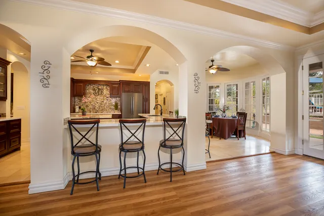 a view of a a dining room and hall with wooden floor