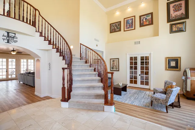 a view of a livingroom with furniture and staircase