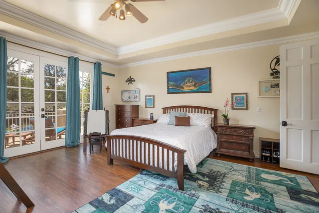 a bedroom with a bed and a table with wooden floor