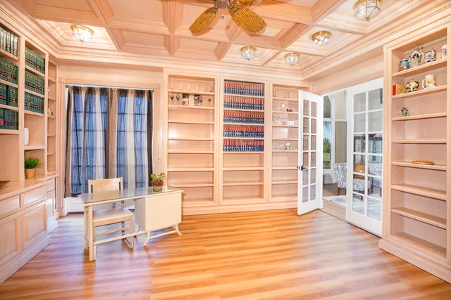 a view of a room with wooden floor and windows