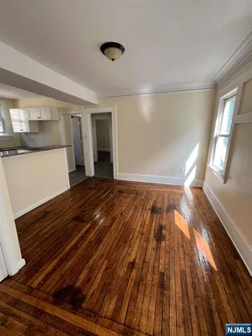 a view of an empty room and wooden floor