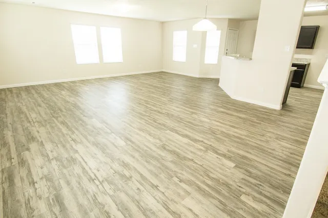 a view of a room with wooden floor and staircase