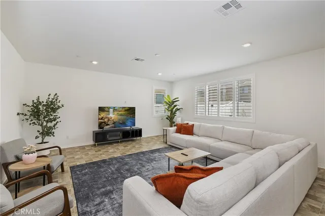 a living room with furniture window and a flat screen tv
