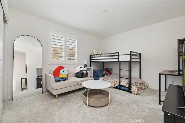 a living room with furniture a window and gym equipment
