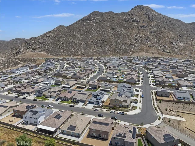 an aerial view of residential houses with outdoor space