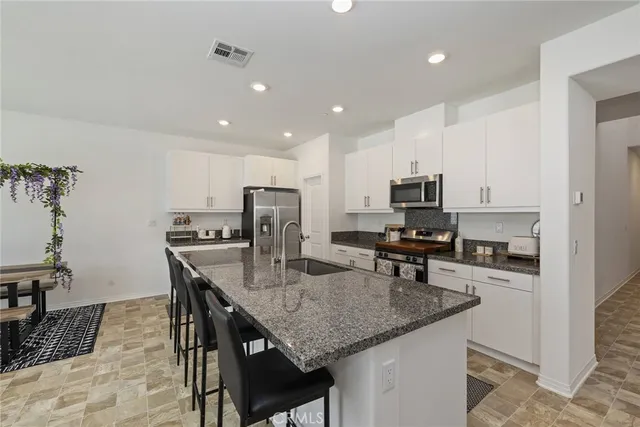 a kitchen with refrigerator and microwave