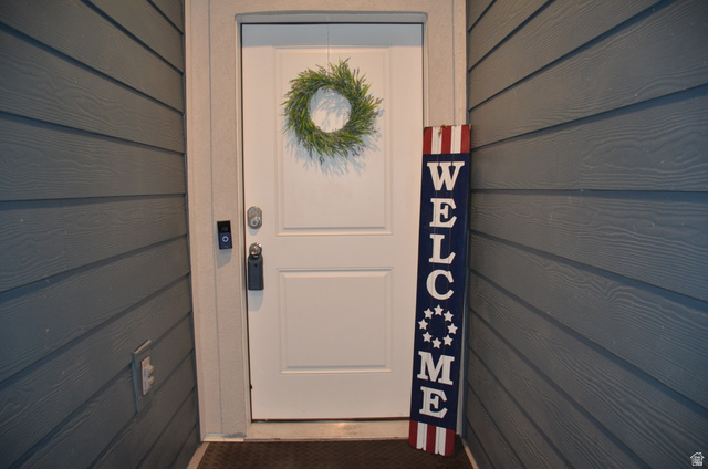 1842 South 1280th Street West Logan, UT 84321 - Photo 2 of 21 Entry door with smart lock system, video doorbell, and plank-style siding