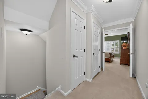 a view of a hallway with room and bathroom
