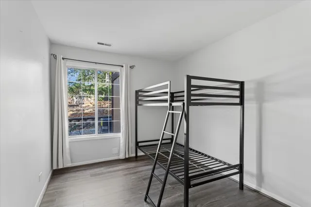 a very nice looking room with wooden floor and a window