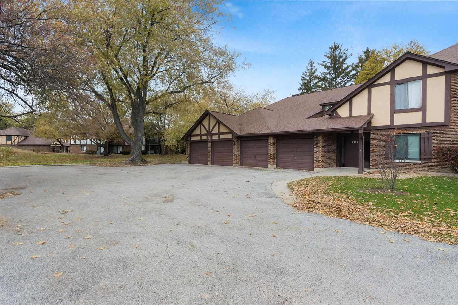1601 Thames Court, Unit A Wheaton, IL 60189 - Photo 2 of 21 a view of a house with a yard and garage