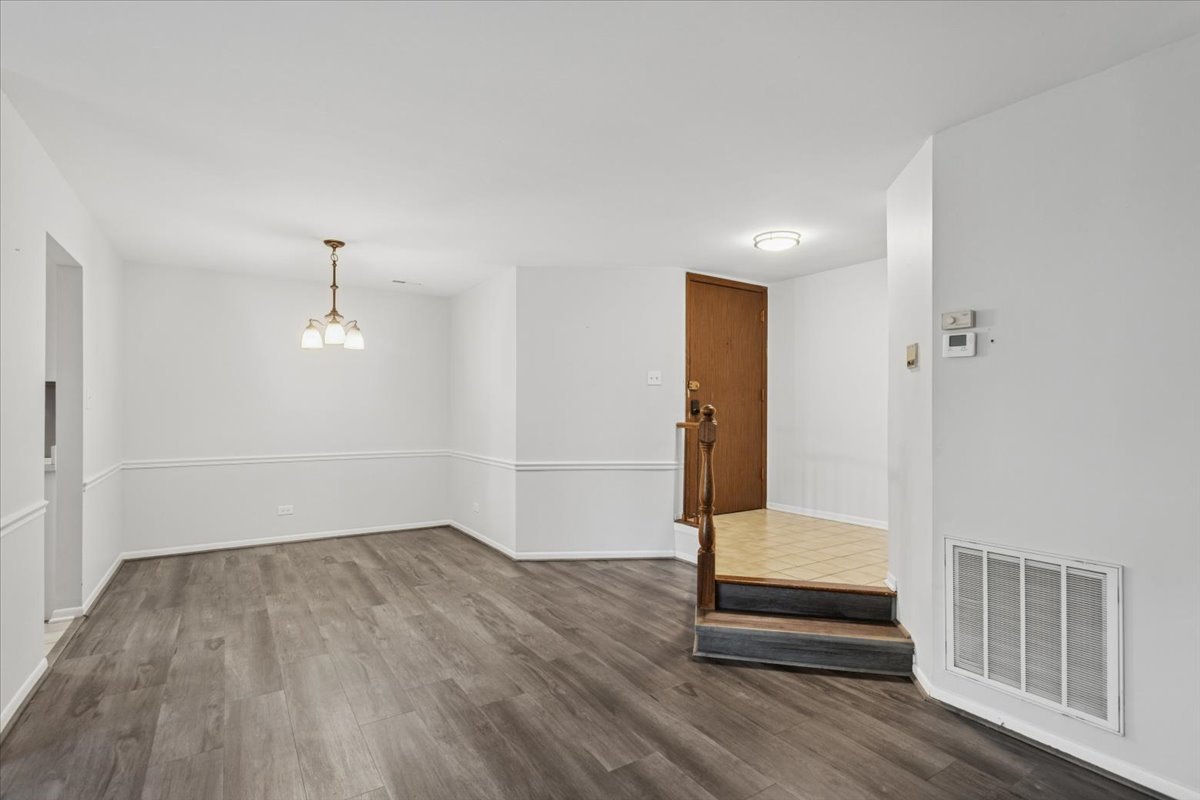 1601 Thames Court, Unit A Wheaton, IL 60189 - Photo 4 of 21 an empty room with wooden floor and bathroom