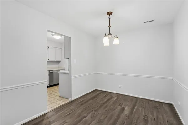 a view of a room with wooden floor and sink