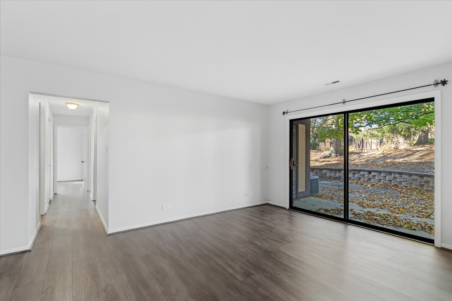 1601 Thames Court, Unit A Wheaton, IL 60189 - Photo 7 of 21 wooden floor in an empty room with a window