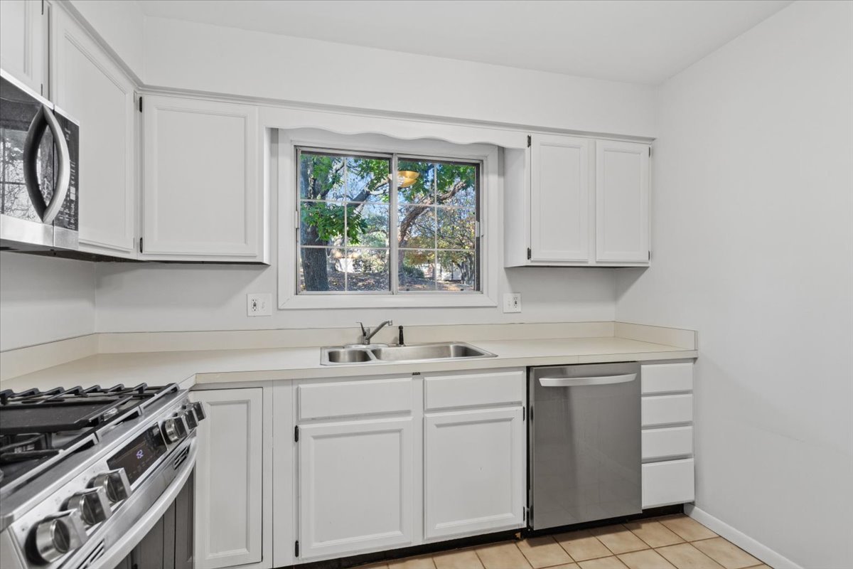 1601 Thames Court, Unit A Wheaton, IL 60189 - Photo 8 of 21 a kitchen with white cabinets and white appliances