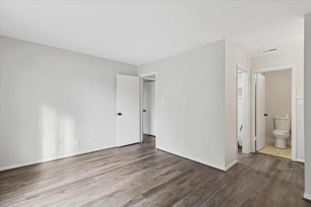 1601 Thames Court, Unit A Wheaton, IL 60189 - Photo 10 of 21 a view of an empty room with wooden floor and a bathroom