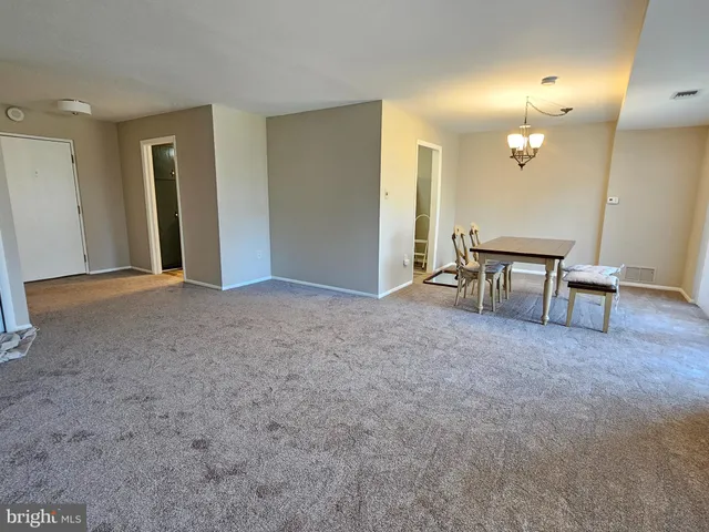 a view of a livingroom with furniture and a window