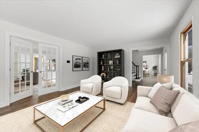 a living room with furniture a rug and a table