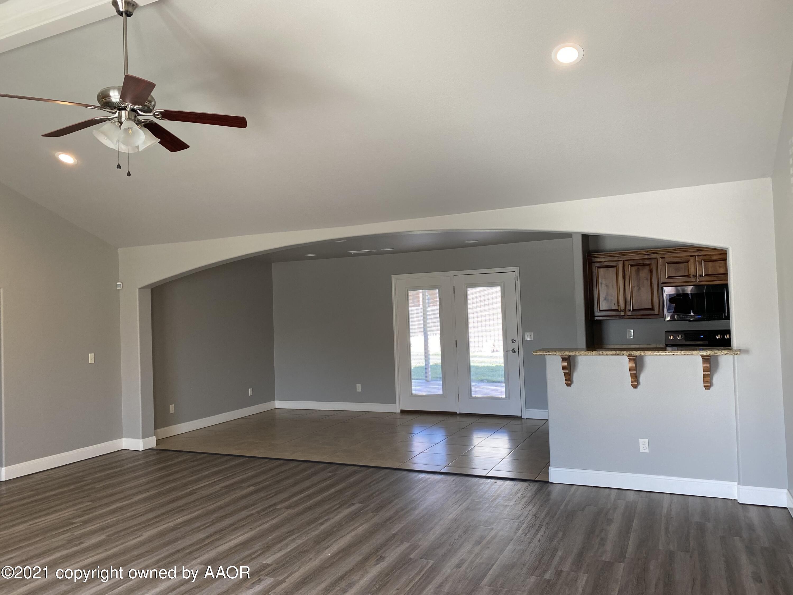 7304 Jacksonhole Drive Amarillo, TX 79118 - Photo 2 of 14 a view of a living room a flat screen tv with wooden floor